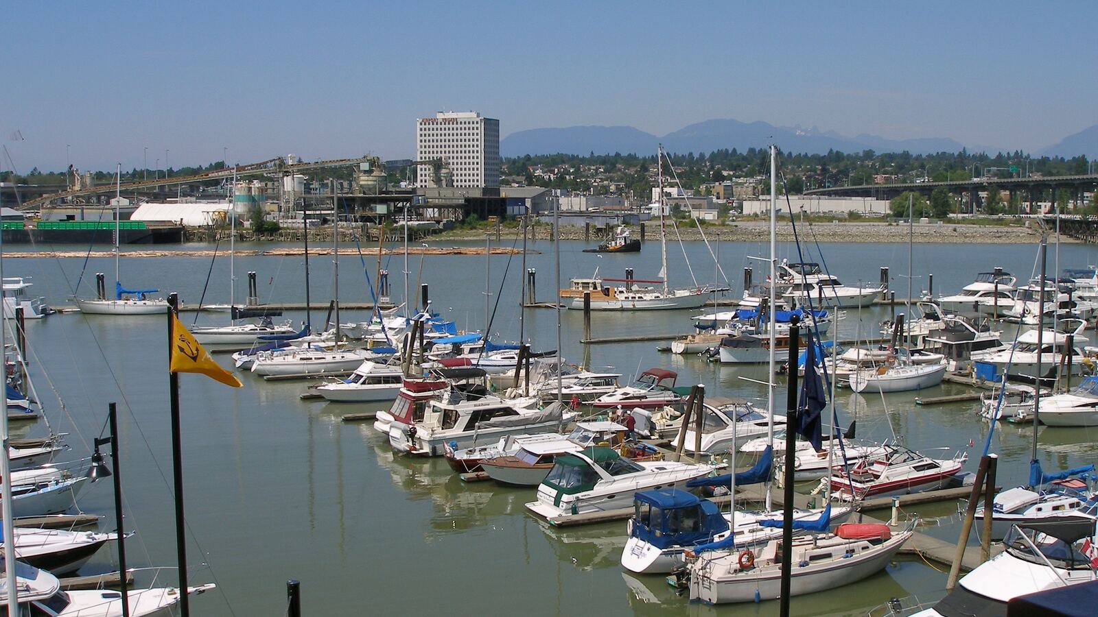 Marina on the Fraser River beside River Rock Casino Resort, with mountains beyond